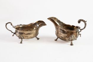 TWO PLAIN SILVER SAUCE BOATS, one VICTORIAN, with leaf capped flying scroll handle, cyma border