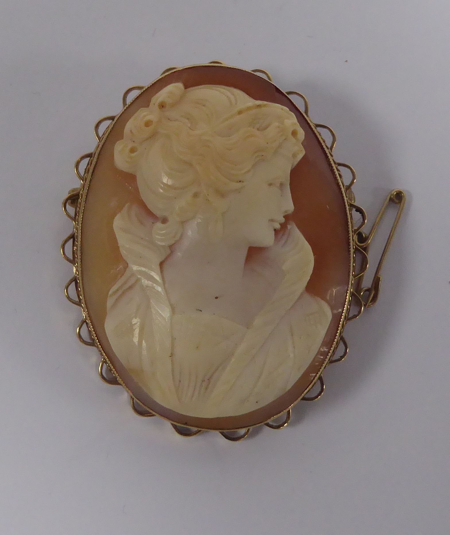 9ct GOLD FRAMED OVAL SHELL CAMEO BROOCH, carved with bust portrait of a lady, 1 7/8in (4.7cm)