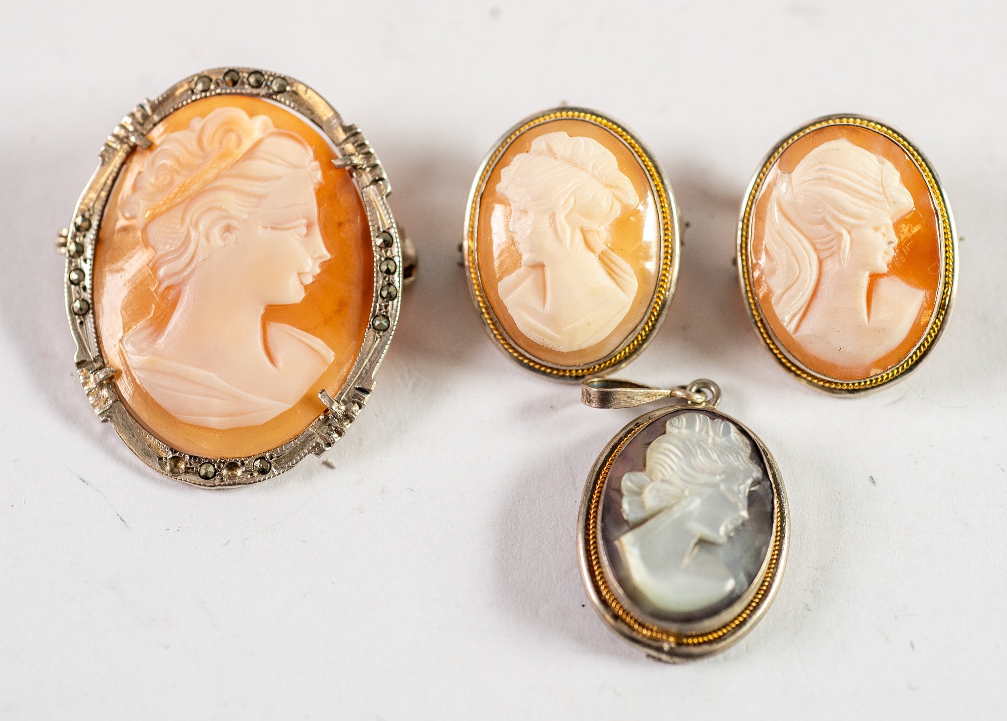 THREE CONTINENTAL SHELL CARVED CAMEO BROOCH PENDANTS and another carved mother of pearl CAMEO, in