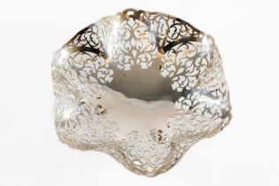 GEORGE VI PIERCED SILVER CAKE DISH, with shaped rim and scroll feet, decorated with foliate scroll