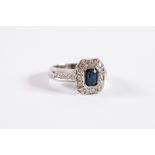 BROAD 18ct WHITE GOLD, SAPPHIRE AND DIAMOND CLUSTER RING, collect set with an oblong sapphire and