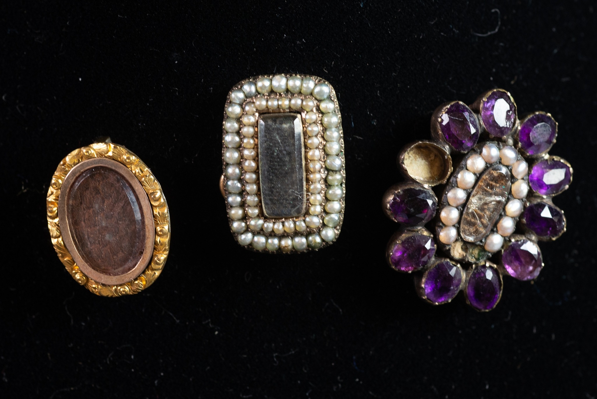 THREE SMALL VICTORIAN BROOCHES each with a glazed hair locket brooches, one oblong with double row