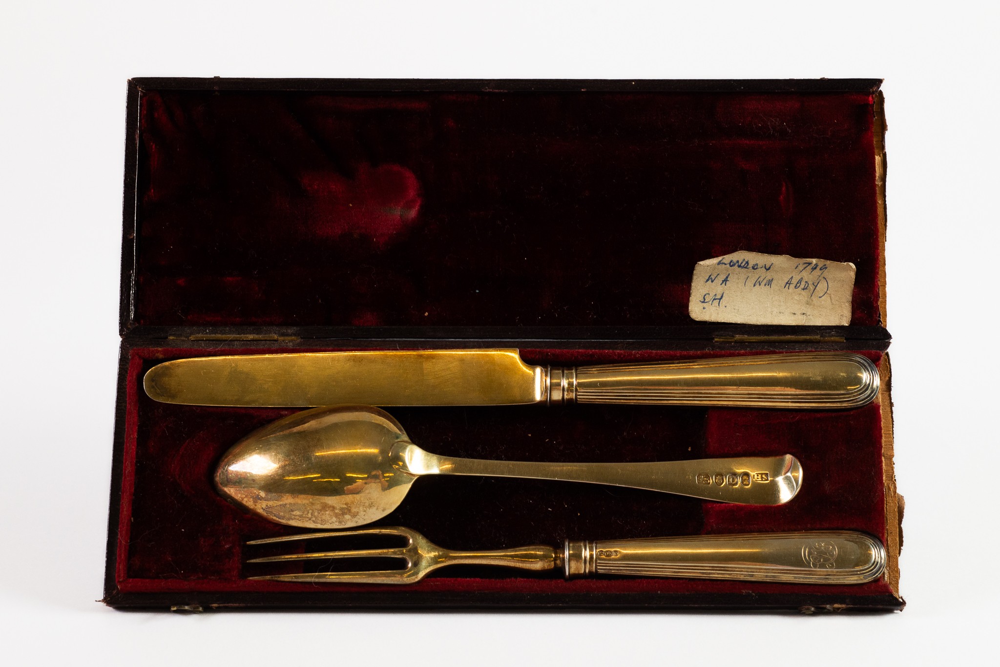 GEORGE III CASED THREE PIECE SILVER GILT CHILD’S CUTLERY SET, the fork and knife with filled