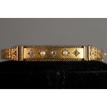 VICTORIAN 15ct GOLD HOLLOW BANGLE, hinge opening, the top half filigree decorated with a plain panel