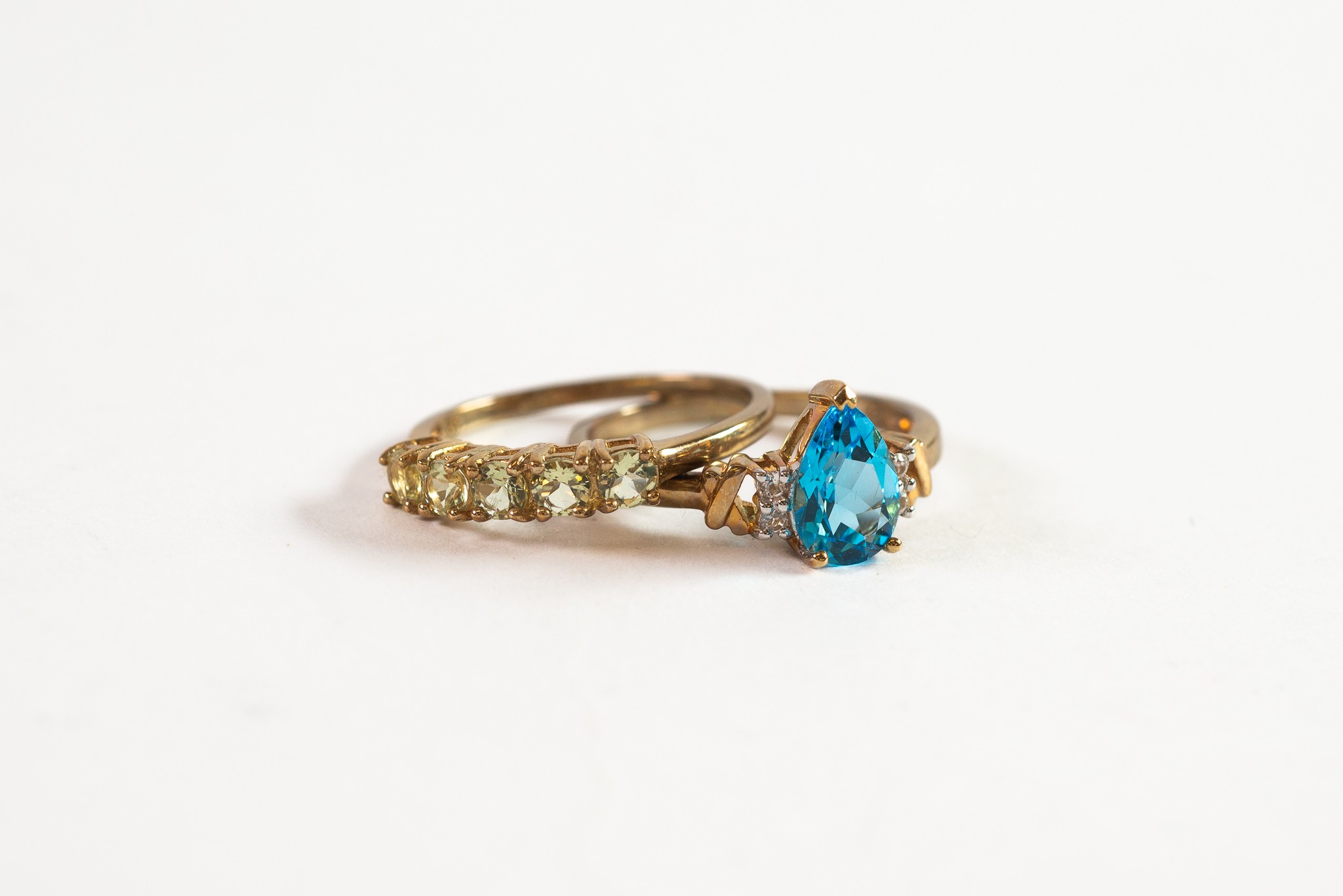 9ct GOLD RING set with tear shaped blue topaz with two tiny diamonds to each shoulder; and 9ct