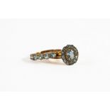 9ct GOLD OVAL CLUSTER RING set with centre oval pale blue stone and surround of small pale blue