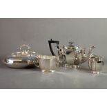 THREE PIECE ELECTROPLATED TEASET, of oval panelled form with black angular scroll handles and oval