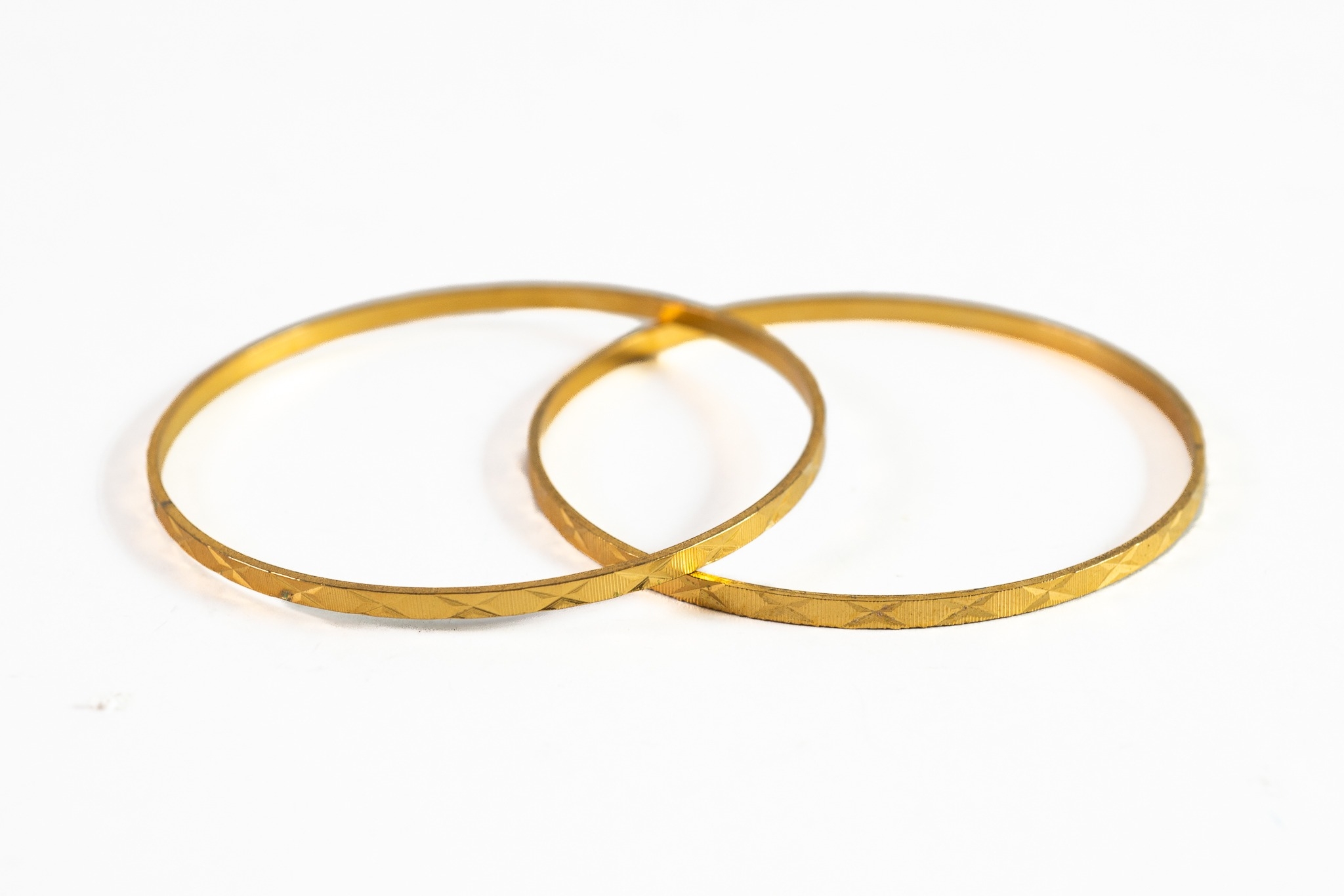 PAIR OF GOLD COLOURED METAL BRIGHT CUT ENGRAVED BANGLES, 12.5gms