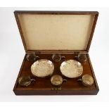 CASED SET OF SIX ANGLO INDIAN EMBOSSED SILVER COLOURED METAL TEA CUPS AND SAUCERS, profusely