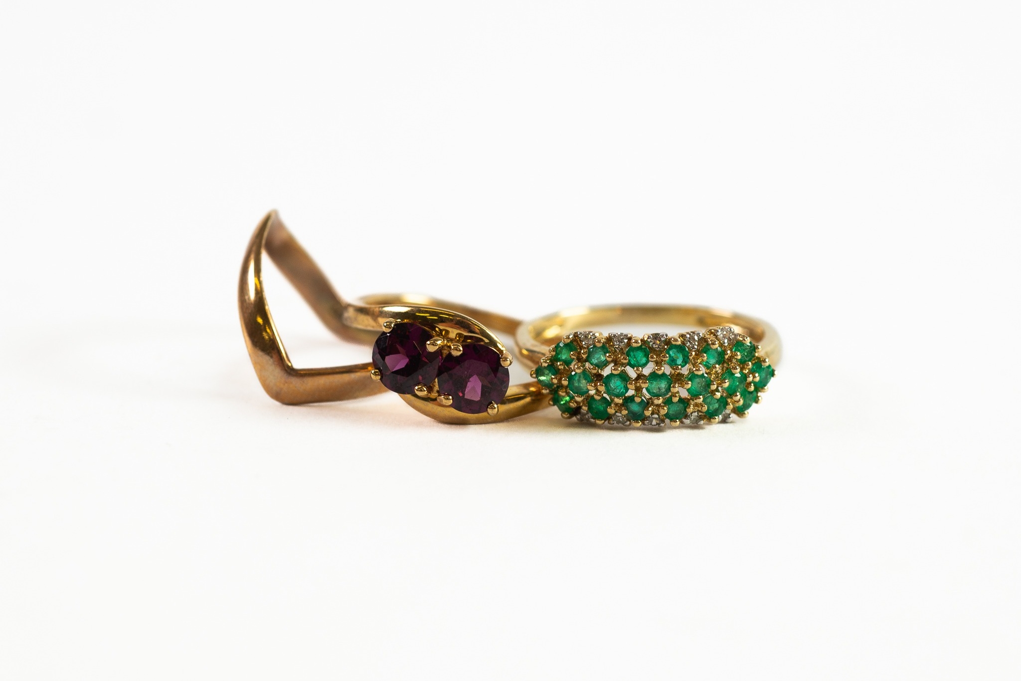 9ct GOLD RING with tiny rows of emeralds surrounded by white sapphires; 9ct GOLD CROSSOVER-STYLE