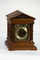 EARLY TWENTIETH CENTURY OAK CASED WINTERHALDER & HOFMEIER MANTLE OR BRACKET CLOCK, the plain brass