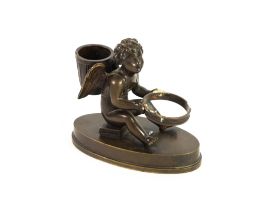 EARLY 19TH CENTURY BRONZE CUPID POUNCE POT AND INKWELL HOLDER, the figure seated on a book, oval