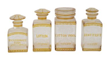 A set of late 19th century Bohemian amber flashed glass toilet bottles