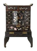 A Japanese Meiji period black lacquer cabinet on stand