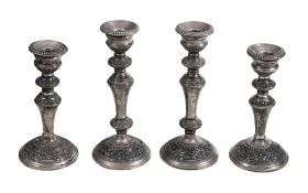 A set of four Elizabeth II filled silver candlesticks