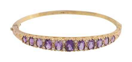 An amethyst, diamond-set and 9ct yellow gold hinged bangle