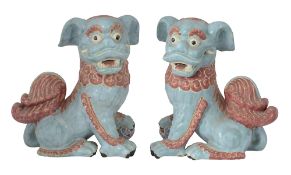 A large pair of Vietnamese polychrome decorated pottery Buddhist lions