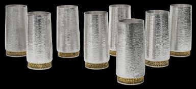 Stuart Devlin. A set of eight Modernist silver and parcel-gilt beakers