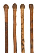 Four Japanese Meiji period bamboo walking sticks c.1900