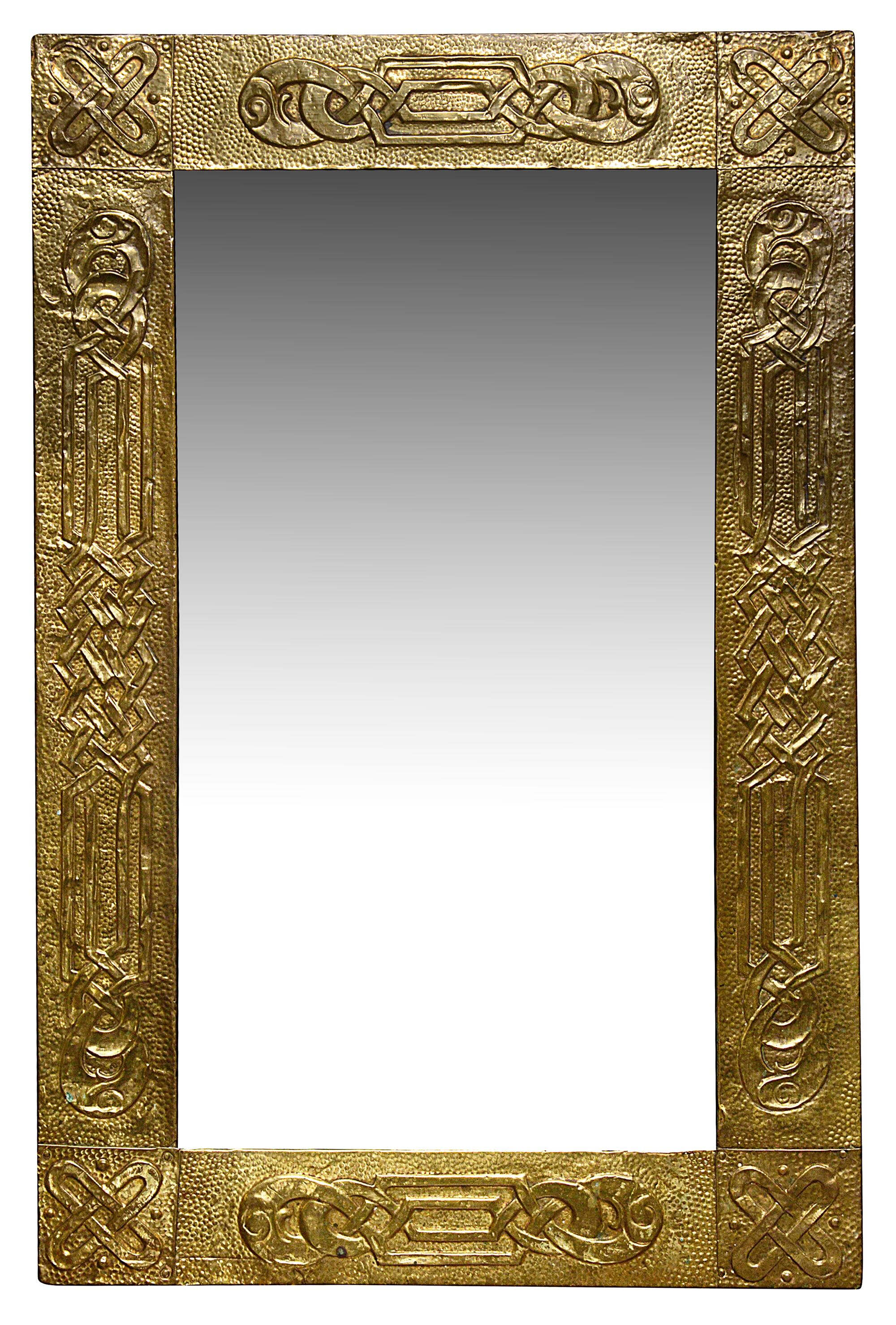 An Arts and Crafts brass embossed mirror