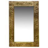 An Arts and Crafts brass embossed mirror