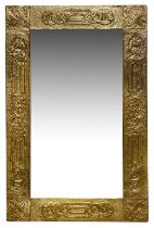 An Arts and Crafts brass embossed mirror