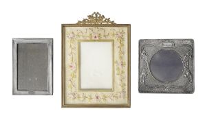 An Edwardian silver Art Nouveau photograph frame and to others