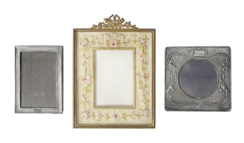 An Edwardian silver Art Nouveau photograph frame and to others