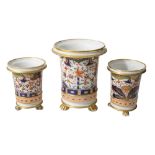 An early 19th century English porcelain garniture of three spill vases (3)