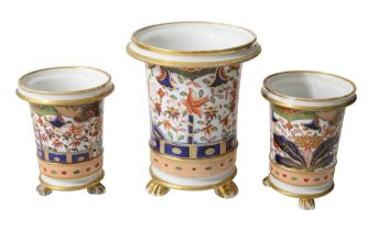 An early 19th century English porcelain garniture of three spill vases (3)