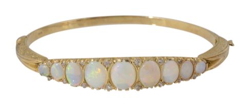 An 18ct yellow gold and opal hinged bangle