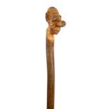 A grotesque novelty carved holly one piece walking stick c.1900