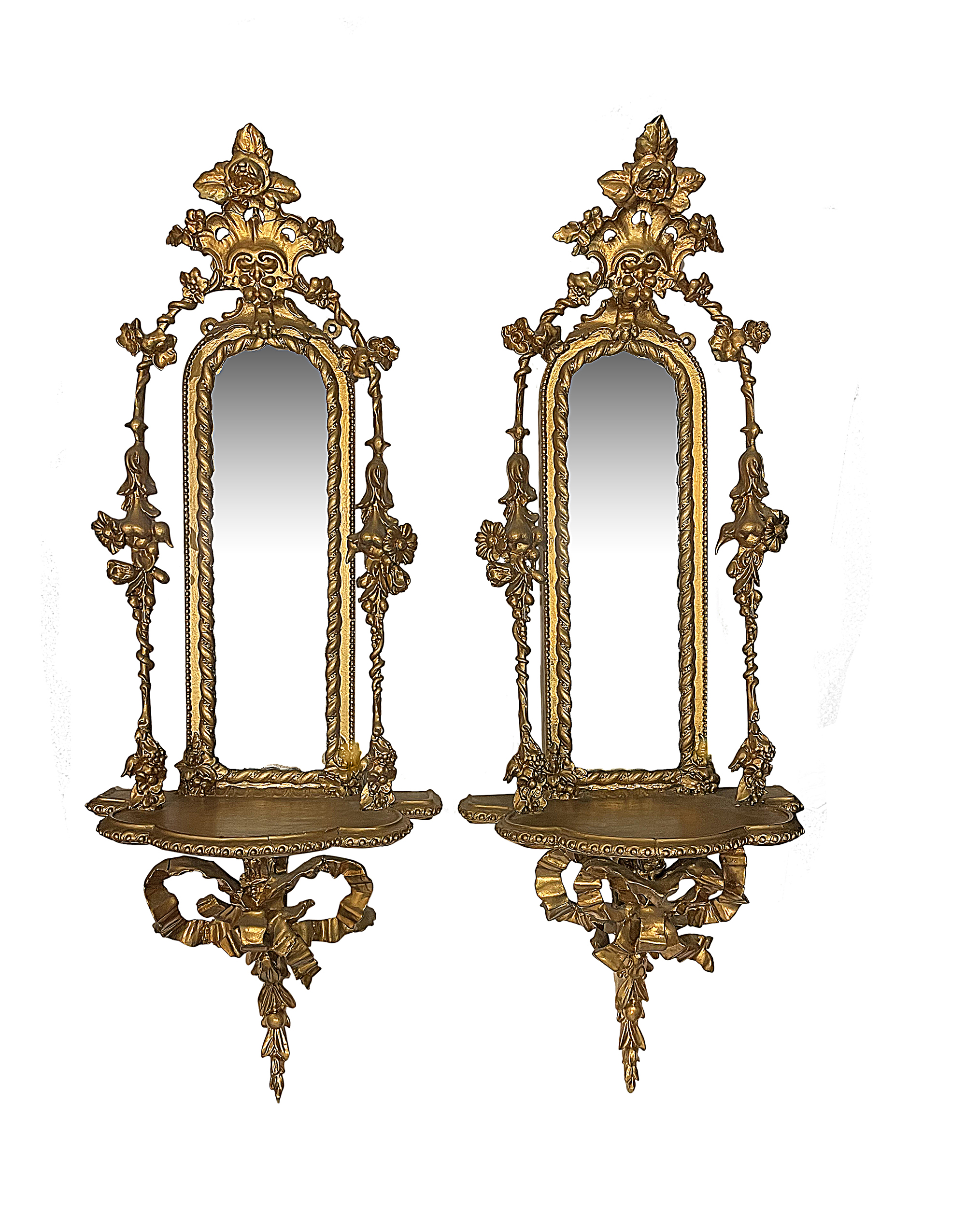 A pair of Victorian giltwood and gesso mirror backed wall brackets