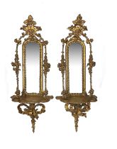 A pair of Victorian giltwood and gesso mirror backed wall brackets