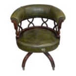 An Edwardian mahogany and leather tub shaped swivel desk chair