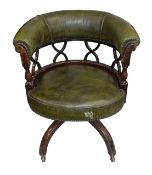 An Edwardian mahogany and leather tub shaped swivel desk chair