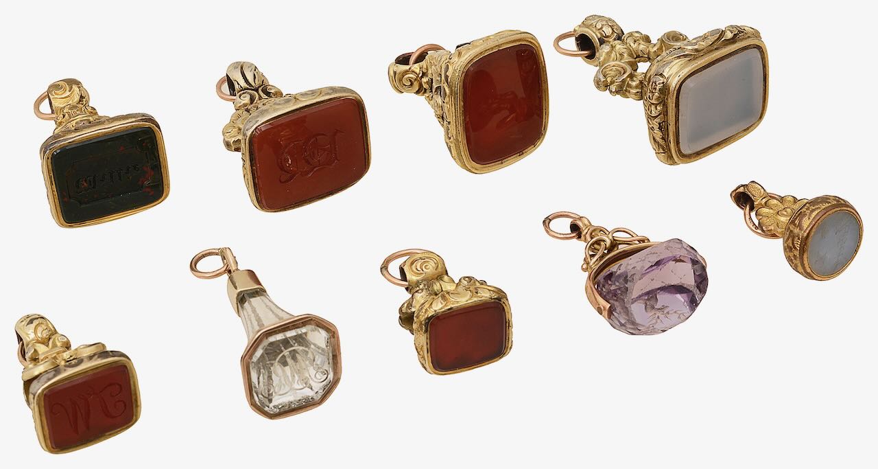 A collection of 19th century and later hardstone and gem-set fob seals