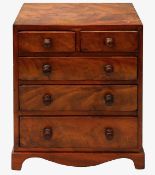 An early 19th century figured mahogany miniature chest of drawers