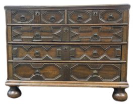 A Charles II joined oak geometric panel fronted chest of drawers