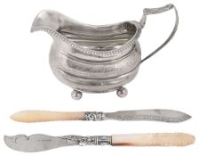A George III silver milk jug and two Victorian butter knives