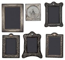 Two Edwardian silver mounted photograph frames and four modern frames