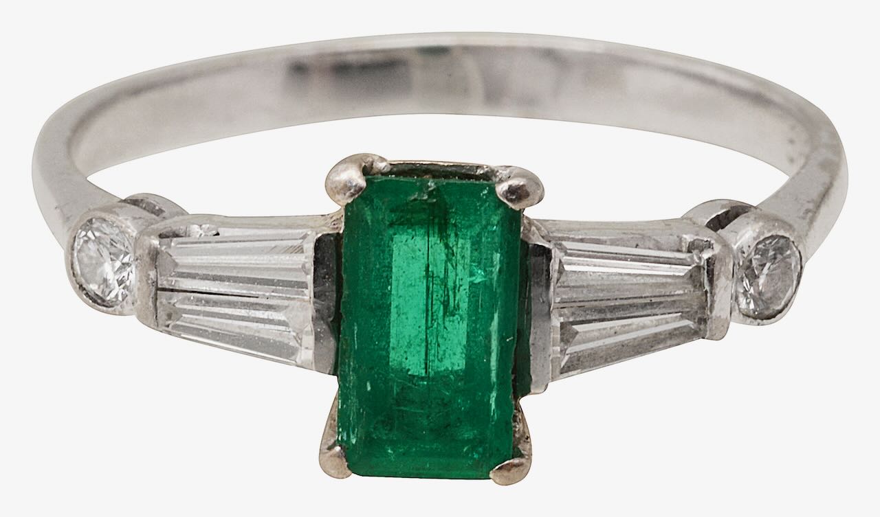 An emerald and diamond ring