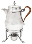 An Edwardian silver coffee pot on an associated silver stand with burner