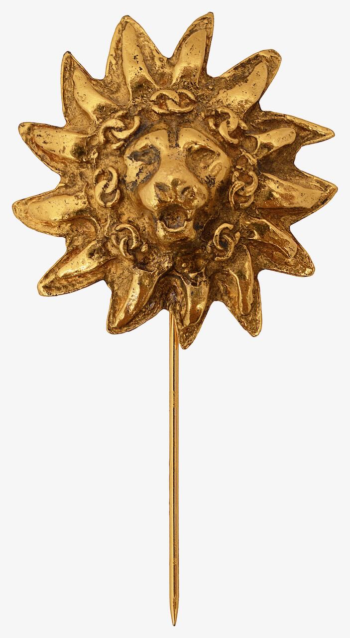 A lion's head stick pin by Chanel