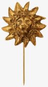 A lion's head stick pin by Chanel