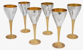 Stuart Devlin. An Elizabeth II Modernist set of silver and parcel-gilt goblets