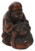 A Japanese Meiji period carved wood netsuke