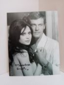 Madeline Smith signed black and white photograph with Roger Moore