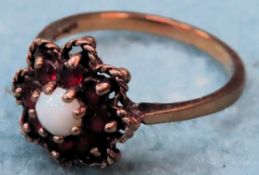 9ct Gold dress ring, set with central pearl type stone surrounded by Rubies. Approx. 2.4g Appears in