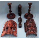 Mixed lot of carved Oriental wooden items including wall masks, busts, candlesticks etc All in
